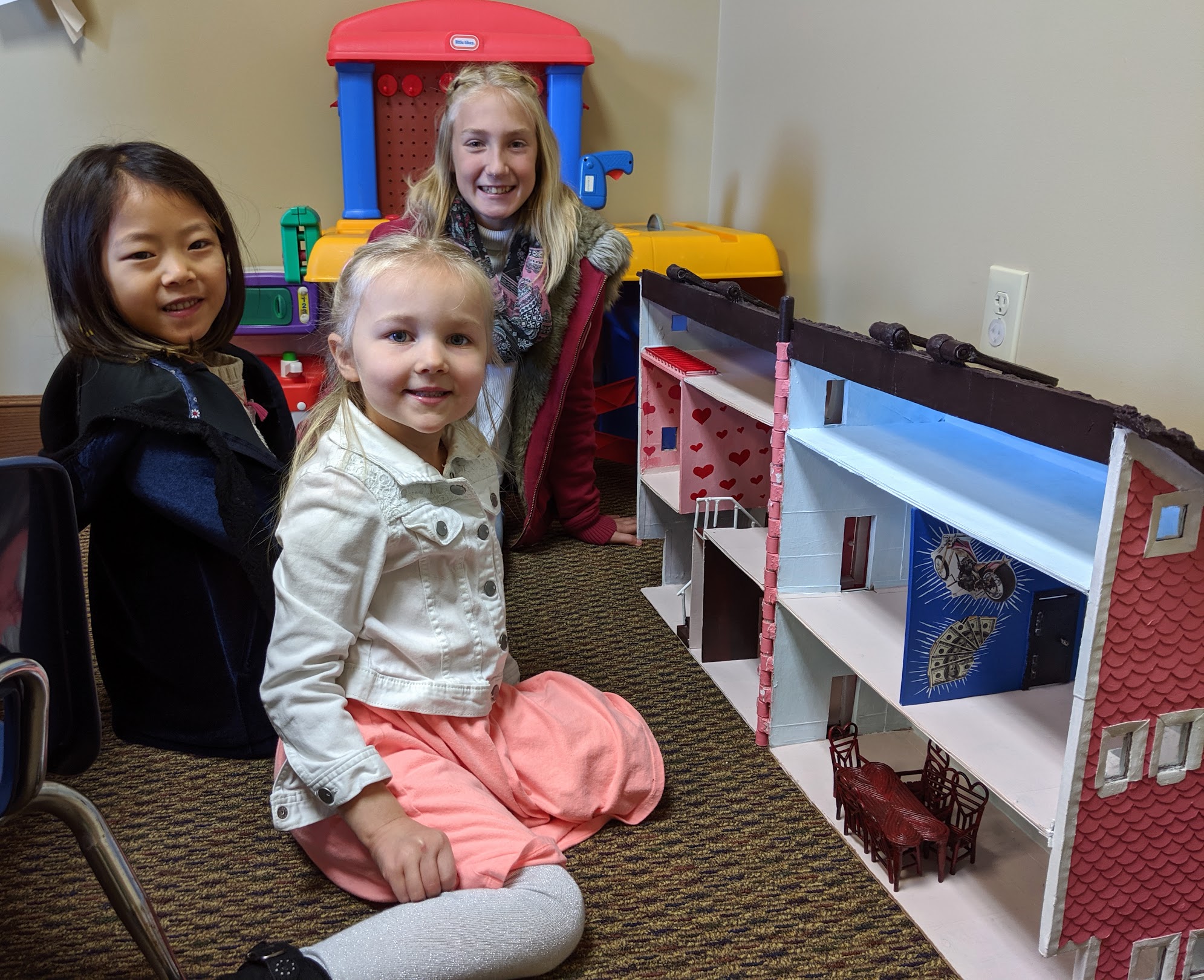 Kids playing with doll house